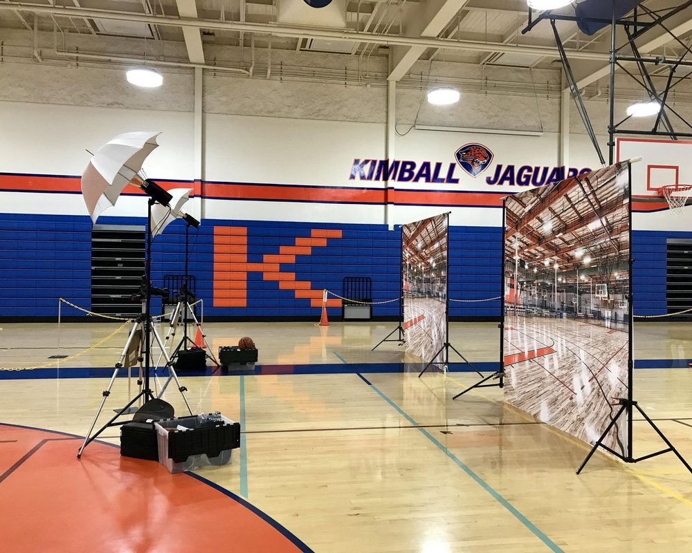 Behind the scenes: portrait lighting set up in a school gym on picture day