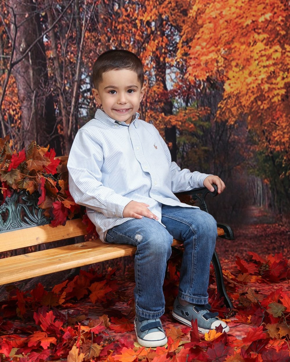 Boy on a bench in an autumn scene